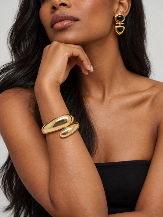 The Vogue Set by Mercer Street: gold-tone Overlap Cuff and black-and-gold Townhouse Earrings worn together